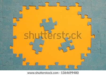 Abstract background of many puzzles on an orange background. The concept of teamwork