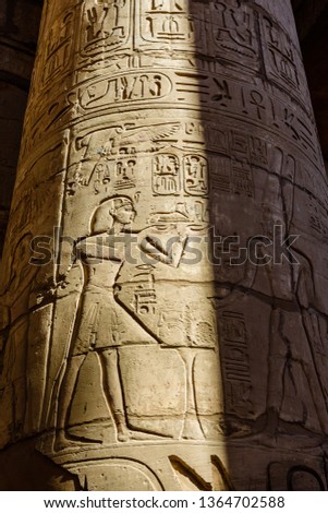 Egyptian ancient hieroglyphs on columns in great hypostyle hall of Karnak temple