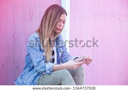 Beautiful Young Adult Girl Influencer Using Smartphone on Outdoor Summer Look with Pink Background