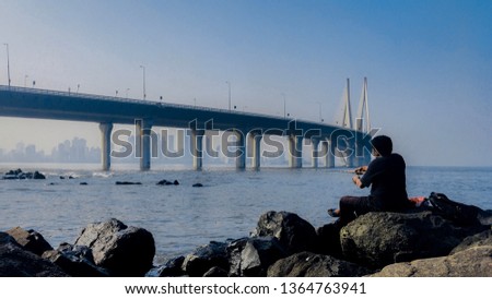 Landscape photography of sea and fisherman