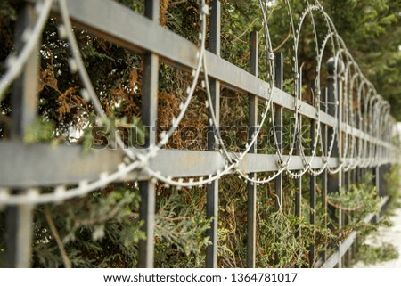 fence protected object with barbed wire. small GRIP
