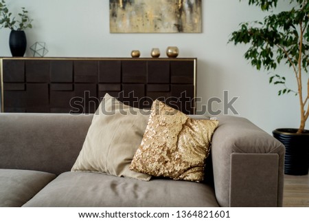 Modern living room with grey sofa with decorative pillows and small round table