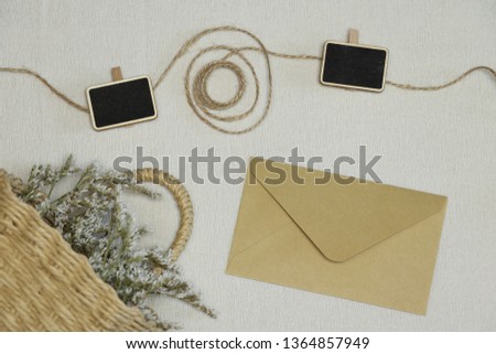 The yellow envelope, thread with wooden pins and basket with flowers