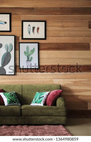 Soft couch near wooden wall in interior of living room