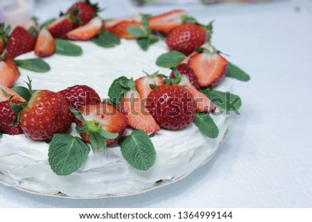 White cake decorated with strawberry and mint