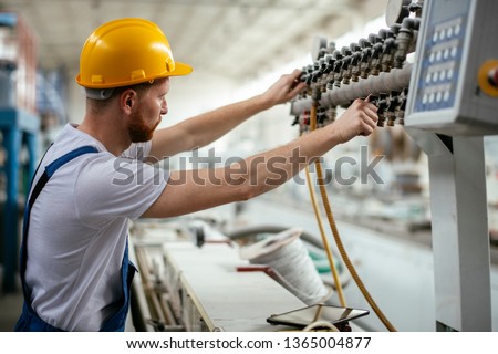 Factory worker. Man working  on the cables and wires.