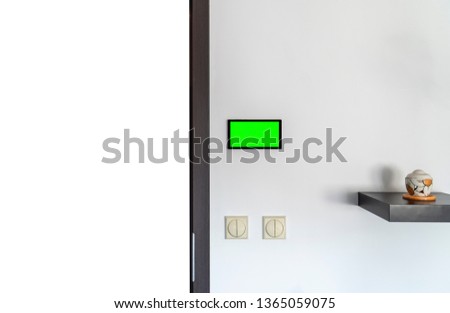 Home automation concept. Device with blank screen hanging on a wall.
