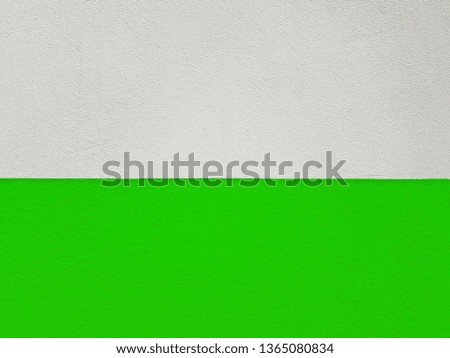 Walls made of cement painted two colors, white top, bottom, green.