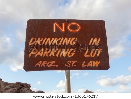 Vintage, rusting NO DRINKING IN PARKING LOT sign. Arizona law.