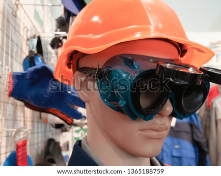 professional personal protective safety engineering equipment for workers - dummy in orange helmet and plastic glasses