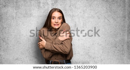 Young caucasian woman going cold due to low temperature