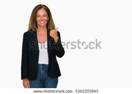 Beautiful middle age business adult woman over isolated background doing happy thumbs up gesture with hand. Approving expression looking at the camera with showing success.