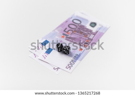 gambling, fortune and casino concept - close up of black dice and euro money on white background