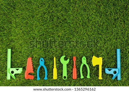 Plastic repair tool for bright colors on green artificial grass, text entry area