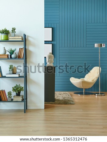 Modern room decoration concept, blue textured wall and close up white wall, grey bookshelf and book style, chair decor.
