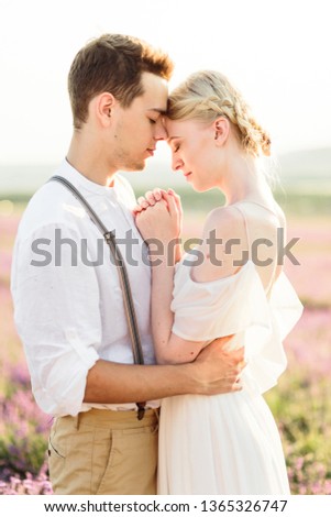 Beautiful portrait of man and women hug each other tender on sunset