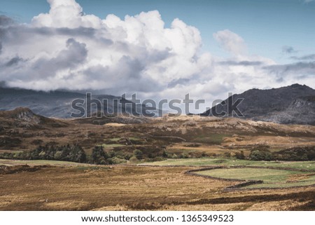 Cloudy sky above scenic mountain valley with rocky hills.Majestic landscape of Lake District National Park in Cumbria, North West UK.Pristine environment of rural Britain.Breathtaking view.