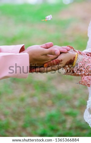 A hand of married couple with wedding ring floating on air. Selective Focus 