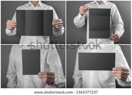 A man in a white shirt holding a black booklet