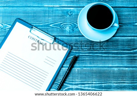 Contract, pen, coffee Cup on wooden table background. business, Finance, contract signing.