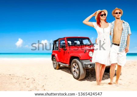Red summer car on beach and two lovers. Free space for your decoration and blue sky. 