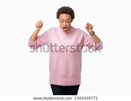 Beautiful young african american woman over isolated background Pointing down with fingers showing advertisement, surprised face and open mouth