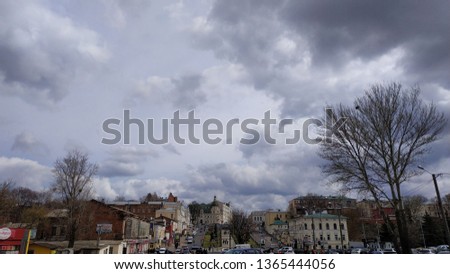 The urban landscape. Buildings, sky and white clouds