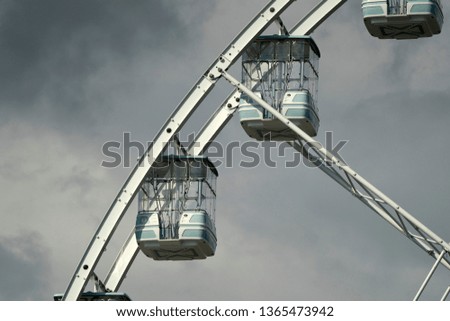 panoramic ferris big wheel detail on cloudy sky background