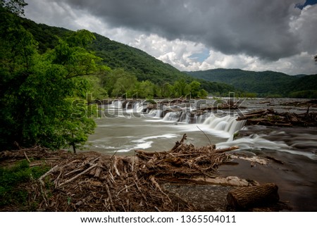 Moody skies over Sandstone Falls within the New River Gorge National Park in West Virginia during a late Spring afternoon.