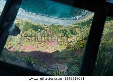 Top view of beautiful orchard on Atlantic ocean shore from Madeira Cabo Girao observation point with transparent floor