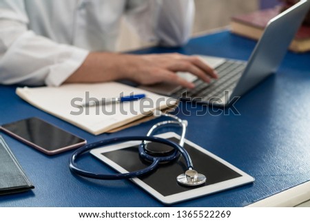 Doctor working in hospital office. Medical healthcare concept.