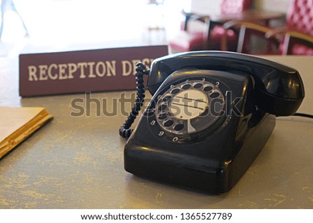 Reception desk with old book and vintage telephone on the table