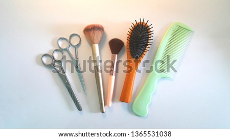 Comb and hairdressing scissors And soft brush On a white background