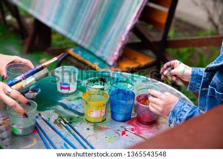 outdoors kinder garden children draw with paints. active leisure time for kids. having fun