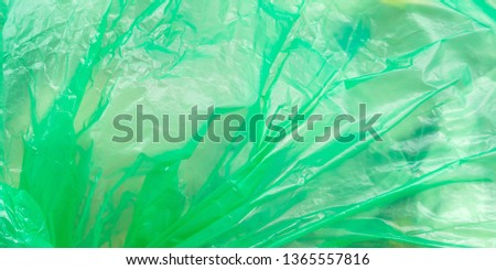 Color plastic bag with garbage to recycle outdoors. Texture