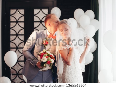 
bride and groom with white balloons