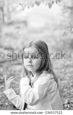 boy sitting in a green forest black and white