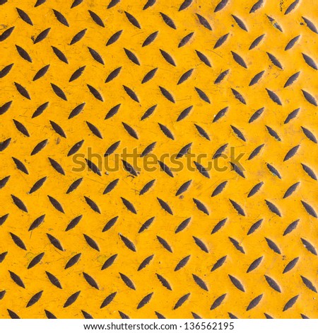 Sheet metal called checkered plate yellow that has a diamond texture used for making non-slip flooring in the industry.