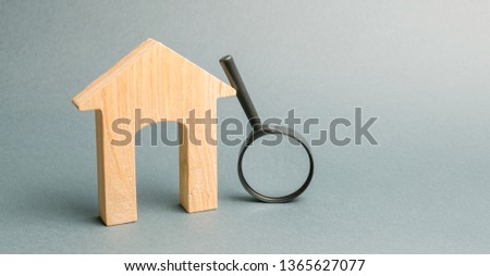 Wooden house and magnifying glass. Property valuation. Home appraisal. Choice of location for the construction. House searching concept. Search for housing and apartments. Real estate