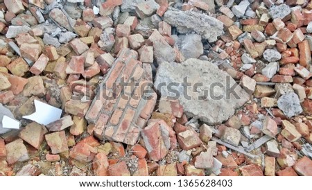 Texture, background, wallpaper, image of heaps of whole and broken red-white bricks on the street after dismantling the building.