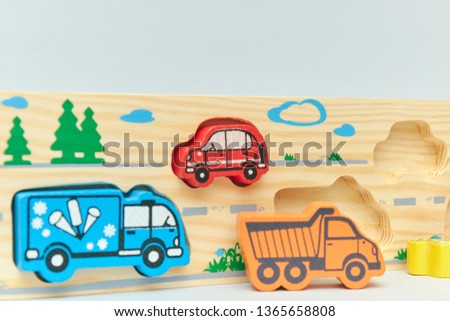 wooden retro typewriter toy on a light background. group of cars with empty space. close-up. educational toys for children. vintage