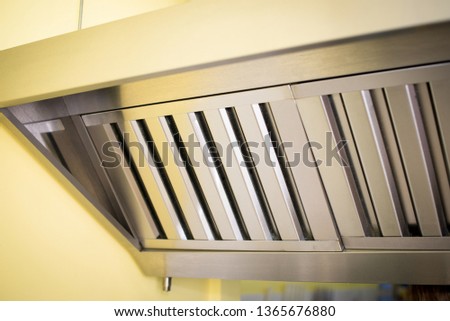 Exhaust systems, hood filters detail in a professional kitchen. Royalty-Free Stock Photo #1365676880