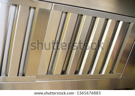 Exhaust systems, hood filters detail in a professional kitchen. Royalty-Free Stock Photo #1365676883