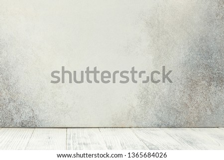 Empty white wooden table in front of stone wall. Copy space