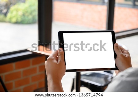 businessman hand working on tablet on wooden desk tablet with blank screen mockup Digital tablet computer