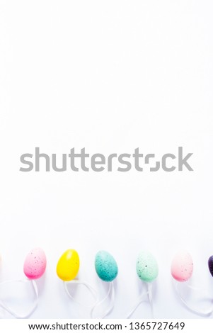 Colorful small eggs on a white background, holiday easter concept, lot of space to add your message