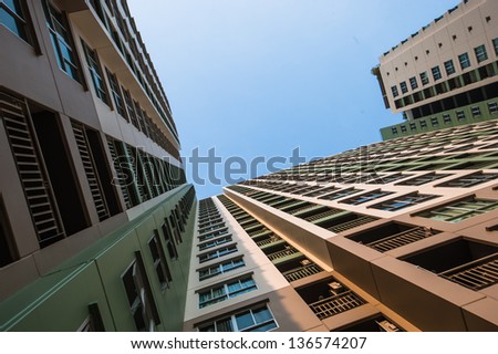 Looking up the sky by side of the condominium
