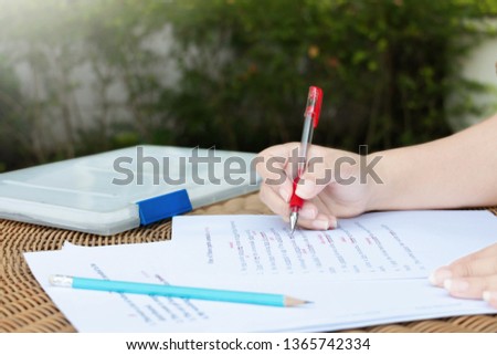proofreading paper on table with red marks for editing service
