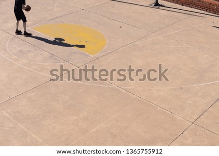 Man shooting alone on basketball court