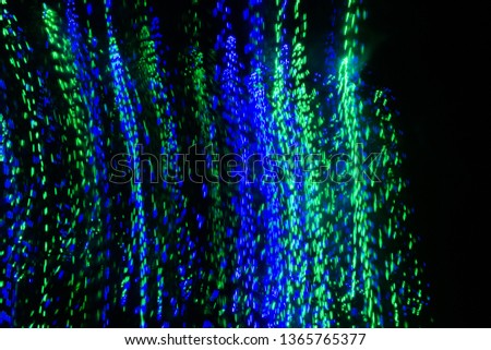 photos of the garland on a long exposure, strip lines dotted lines of different colors on a black background